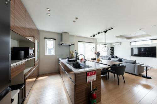 a kitchen and living room with a couch and a table at The Verite in Asahikawa
