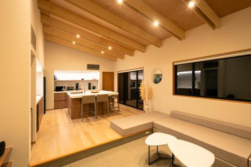a living room with a couch and a table at mysa yamanakako in Yamanakako