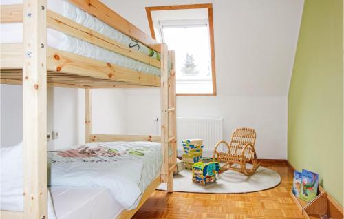 a bedroom with a bunk bed and a chair at Nice Home In Drochtersen in Drochtersen