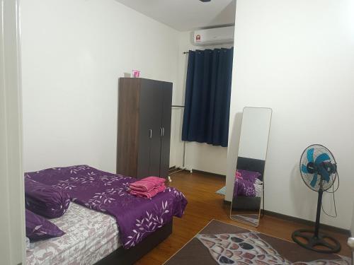 a bedroom with a bed and a mirror in it at Layyin's Damai Residences in Shah Alam