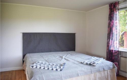 a bed with two pillows on it in a bedroom at 2 Bedroom Nice Home In Åsenhöga in Åsenhöga