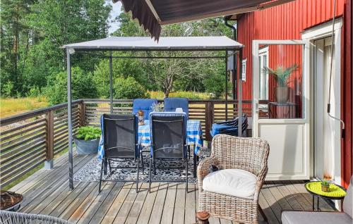 a deck with chairs and a table and a gazebo at Beautiful Home In Vimmerby With Kitchen in Vimmerby