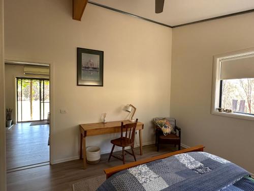 a bedroom with a desk and a bed and a desk at Peaceful getaway in stunning bush setting in Albury