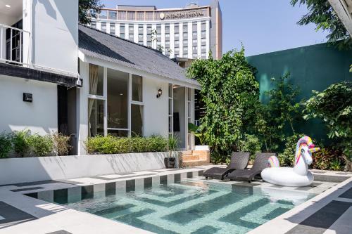 a pool with a swan in the middle of a house at CLEOPATRA POOL VILLA I Prime Location - Near The Famous Night Bazzar, 5 Minutes from the old city I Daily Housekeeping in Chiang Mai