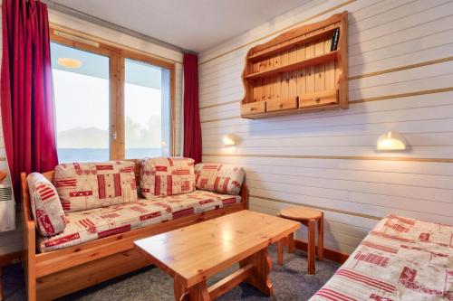 a living room with a couch and a table at Quartier La Forêt - maeva Home - Studio 4 personnes - Sélection MAE-1241 in Valmorel