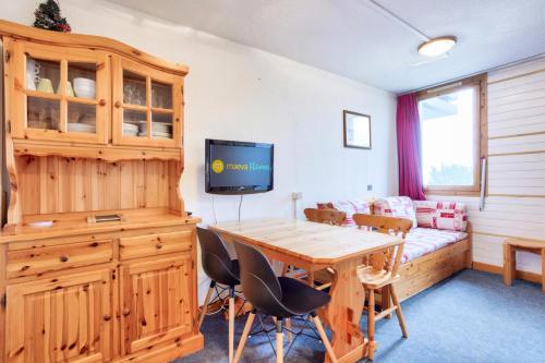 a living room with a table and a couch at Quartier La Forêt - maeva Home - Studio 4 personnes - Sélection MAE-1241 in Valmorel