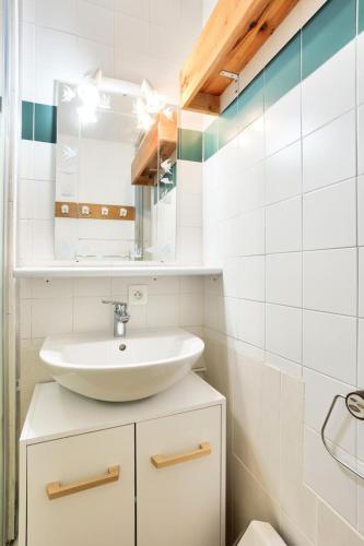 une salle de bain avec un lavabo et un miroir dans l'établissement Quartier La Forêt - maeva Home - Studio 4 personnes - Sélection MAE-1241, à Valmorel
