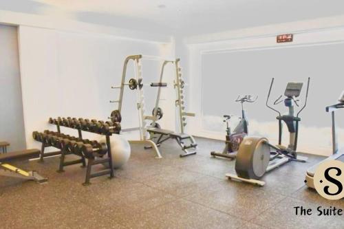 a gym with several treadmills and machines in a room at Condo in Las Piñas- The Suite Spot Alabang in Manila