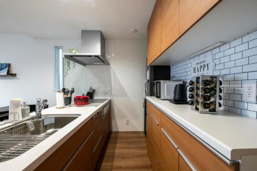 a kitchen with a sink and a counter at Nakajima Nouveau in Sapporo