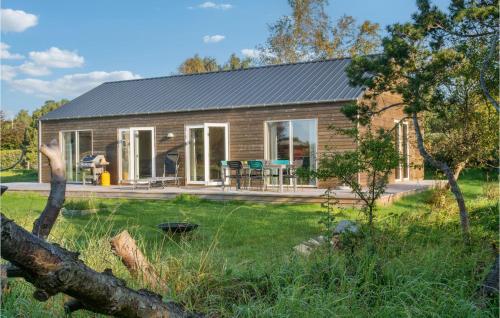 a log cabin with a garden and a yard at Gorgeous Home In Sejerø With Wifi in Sejerby
