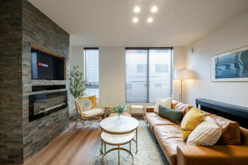 a living room with a couch and a fireplace at Nakajima Nouveau in Sapporo