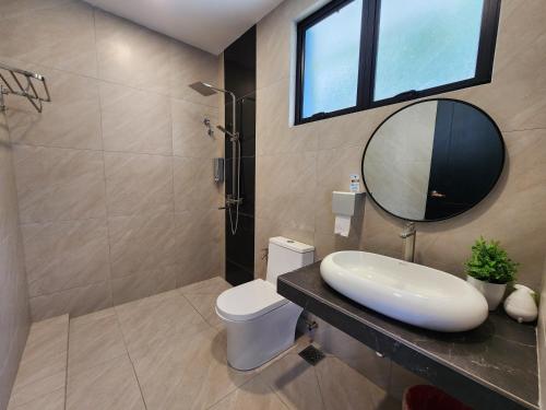a bathroom with a sink and a mirror at Ipoh Eden Pool Villa Suites in Ipoh