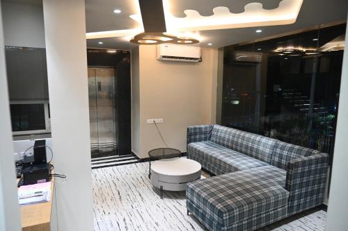 a living room with a couch and a table at The Infigo in Beherāpāt