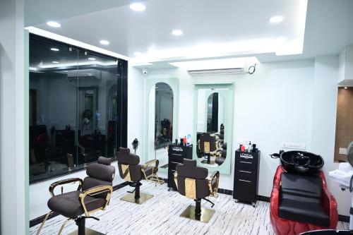 a hair salon with a bunch of chairs and mirrors at The Infigo in Beherāpāt