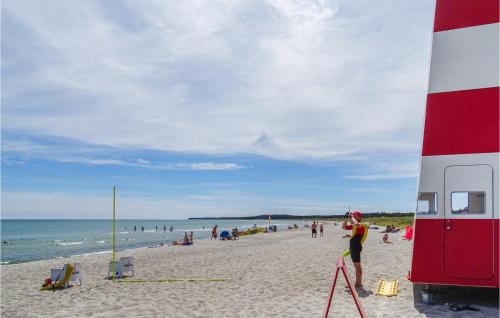 a group of people on a beach with the ocean at Lovely Home In Grenaa With Kitchen in Grenå