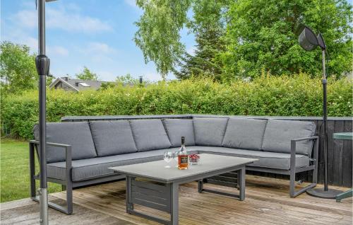 a couch and a table on a patio at Lovely Home In Grenaa With Kitchen in Grenå