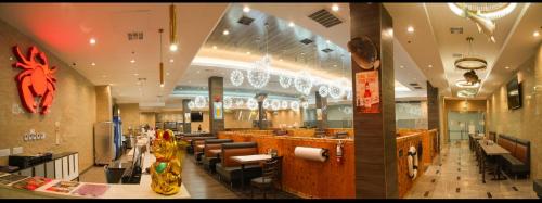 a restaurant with a bar and chairs in a room at LA Crystal Hotel -Los Angeles-Long Beach Area in Carson