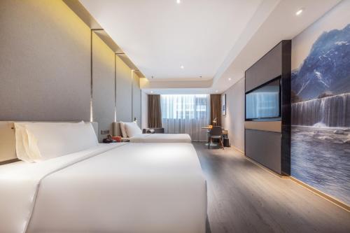 Ένα ή περισσότερα κρεβάτια σε δωμάτιο στο Atour Hotel Kunming Economic Development Zone