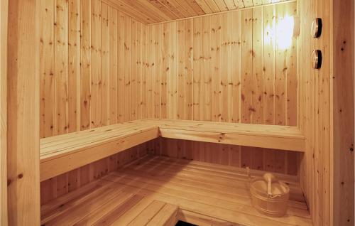 an empty wooden sauna with a bucket in it at Holiday Home Nørre Nebel 42 in Lønne Hede