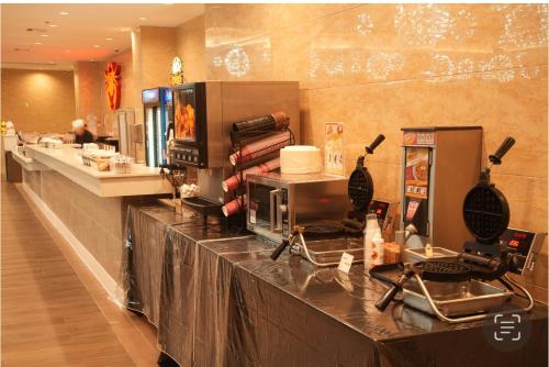 a buffet line in a restaurant with a counter at LA Crystal Hotel -Los Angeles-Long Beach Area in Carson
