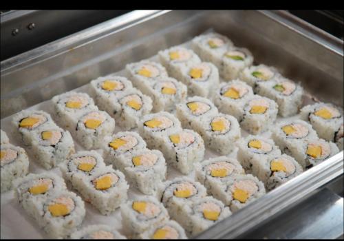 a tray full of sushi with cheese on it at LA Crystal Hotel -Los Angeles-Long Beach Area in Carson