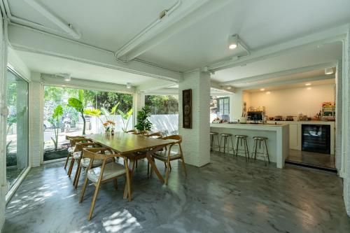 a dining room and kitchen with a table and chairs at CLEOPATRA POOL VILLA I Prime Location - Near The Famous Night Bazzar, 5 Minutes from the old city I Daily Housekeeping in Chiang Mai