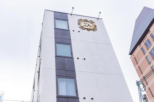 a building with a clock on the side of it at JA Hotel Shinfukae in Osaka