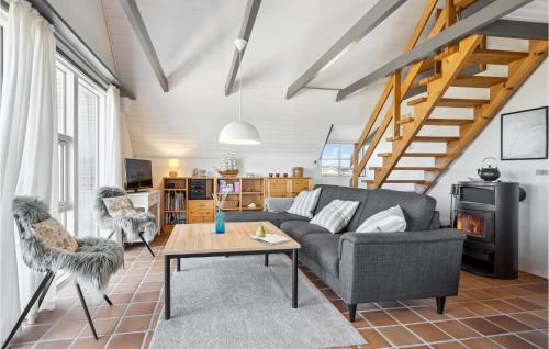 a living room with a couch and a table at Nice Home In Hvide Sande With Sauna in Bjerregård