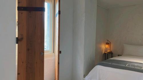 a small bedroom with a bed and a window at Chill Roof Hotel in Taipei