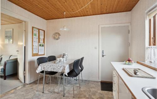 a kitchen and dining room with a table and chairs at Lovely Home In Bogense With Kitchen in Bogense