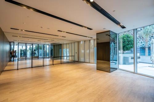 a large room with glass doors and wooden floors at GuestReady - Elegant 1BR l Premium Amenities in Dubai