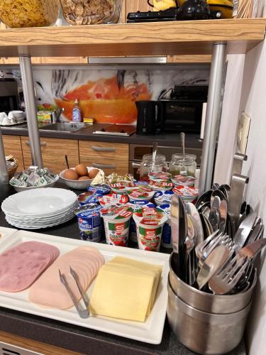 a kitchen counter with alot of food and utensils at B&B By The Way in Ljubljana