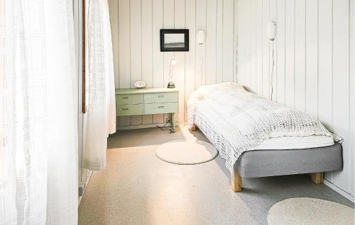 a bedroom with a bed and a dresser at 3 Bedroom Lovely Home In Mosvik in Mosvik