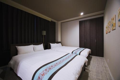 Ένα ή περισσότερα κρεβάτια σε δωμάτιο στο INOVE VILLA Osaka