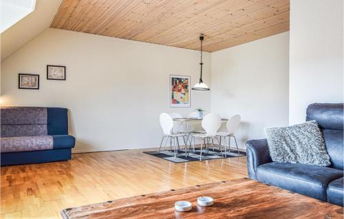 a living room with two blue chairs and a table at Apartment Blåvandvej Blåvand Iv in Blåvand