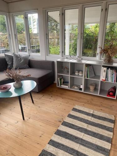 a living room with a couch and a table at Cosy Holiday Home - 300 m to beautiful beach and cafés in Karrebæksminde