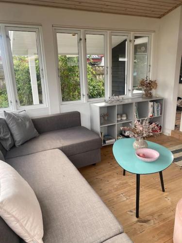 a living room with a couch and a table at Cosy Holiday Home - 300 m to beautiful beach and cafés in Karrebæksminde