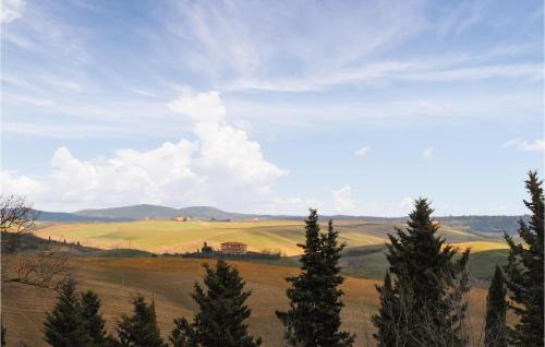 a view of a field with trees in the foreground at Cozy Home In San Quirico Dorcia in San Quirico dʼOrcia