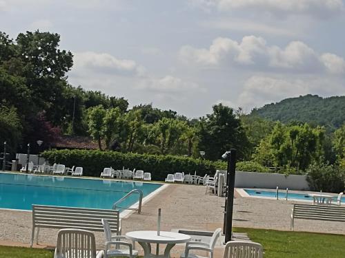 a pool with chairs and a table and a table and chairs at La casa di Trude in Padenghe sul Garda