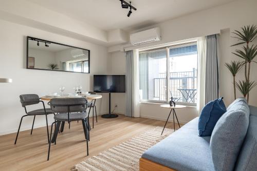 a living room with a couch and a table at Dash Living Asakusa East in Tokyo