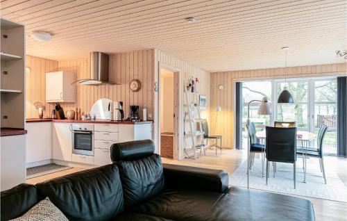a living room with a couch and a kitchen at Beautiful Home In Rønne With Wifi in Rønne