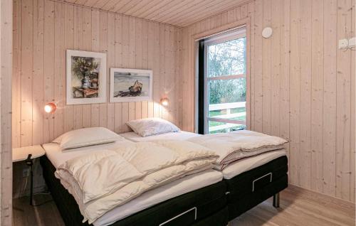 a large bed in a room with a window at Beautiful Home In Rønne With Wifi in Rønne