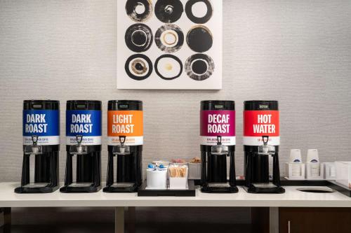 a table with a bunch of coffee bottles on it at Hampton Inn Roanoke/Hollins - I-81 in Roanoke