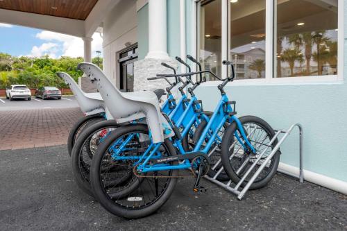 two bikes are parked outside of a building at Surf and Sand Fernandina Beach at Amelia Island, an Ascend Collection Hotel in Fernandina Beach