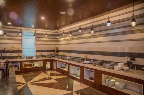 a large kitchen with a counter with white plates at The Abduz in Leh