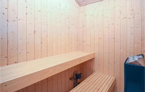 a wooden sauna with a wooden bench in it at Beautiful Home In Nakskov With Sauna in Nakskov