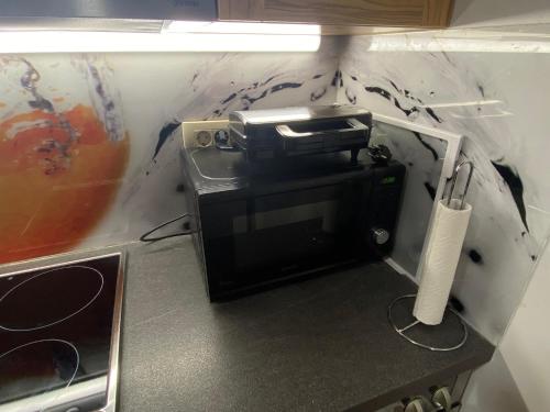 a microwave sitting on top of a kitchen counter at B&B By The Way in Ljubljana