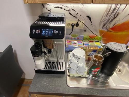 a coffee maker sitting on top of a counter at B&B By The Way in Ljubljana