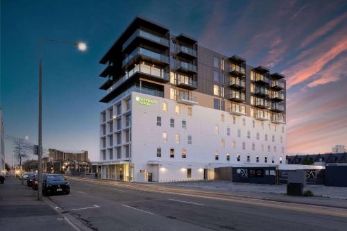 a large white building on the side of a street at Wyndham Garden Christchurch Kilmore Street in Christchurch