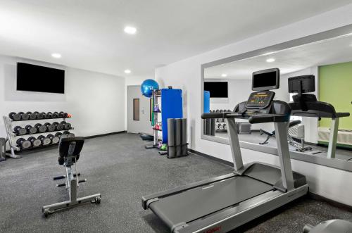 a fitness room with a gym with a treadmill and weights at Spark by Hilton Winston-Salem University in Winston-Salem